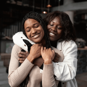 Woman embracing a younger woman, smiling